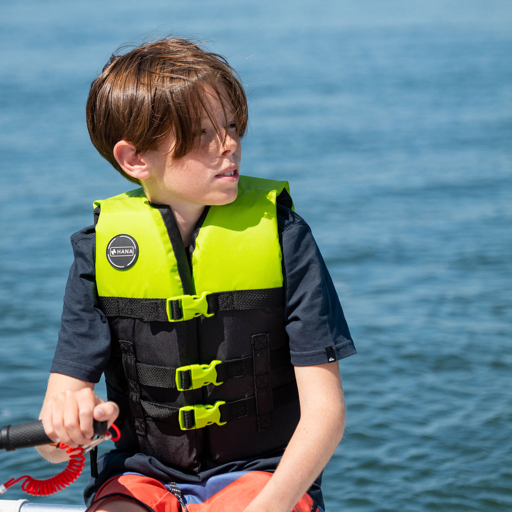 Child on a boat wearing the HANA Dual Sport Youth 50 N vest
