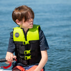 Child on a boat wearing the HANA Dual Sport Youth 50 N vest