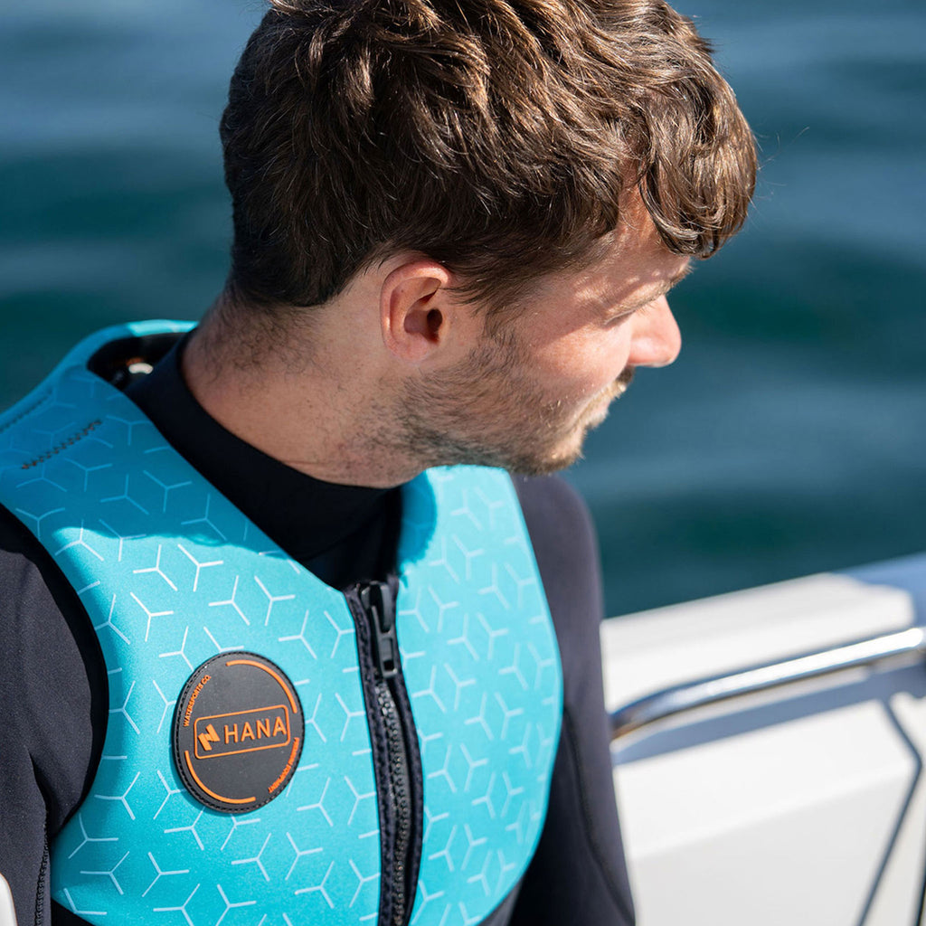 HANA Neo Vest 50 N life jacket, Light Blue – close-up of the HANA badge, worn by a man