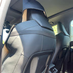 Back of a car seat fitted with the HANA cover, straps around the headrest