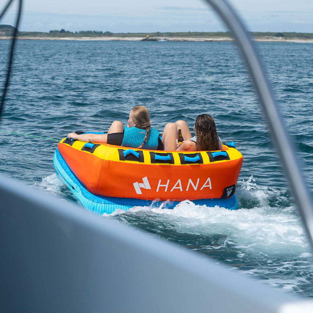 HANA Nemo towable tube – two riders being towed at sea