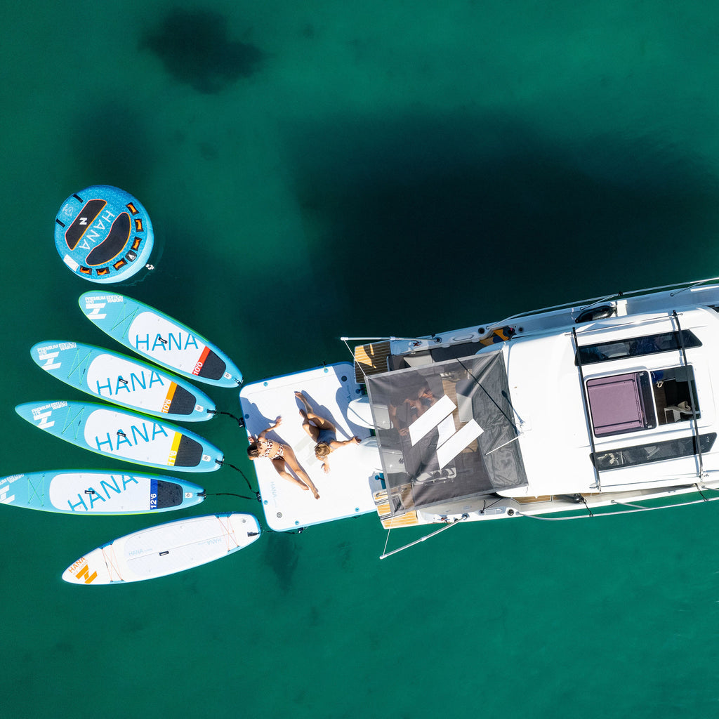 HANA Yachting inflatable platform – aerial view at the stern of a catamaran, with paddle boards moored