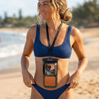 Woman wearing the HANA waterproof pouch with accessory pocket on the beach