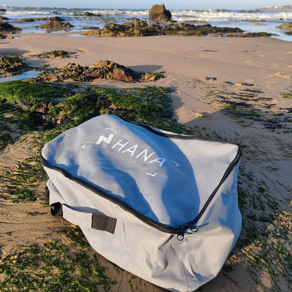 HANA Premium inflatable surfboard carry bag on the beach
