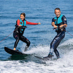 Two wakeboarders behind a boat with the HANA rope and handle