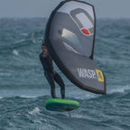 Wingfoil rider on a choppy sea, wearing a waist leash