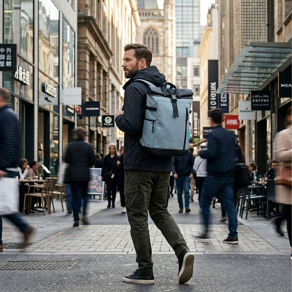 Man wearing the HANA XPlorer 25L backpack in Graphite Blue in the city